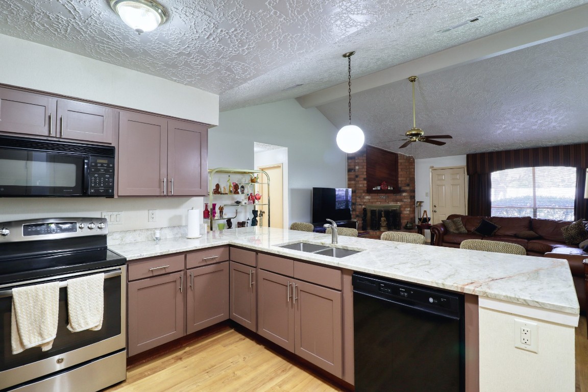 3446 Cheaney Drive Houston, TX 77066 - Photo 18 of 49 a kitchen with a sink stove and microwave
