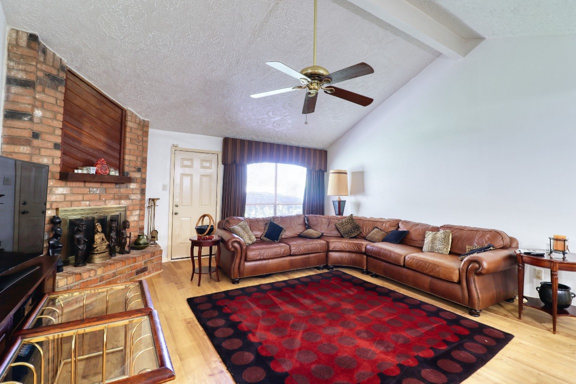 3446 Cheaney Drive Houston, TX 77066 - Photo 2 of 49 a living room with furniture a rug and a fireplace