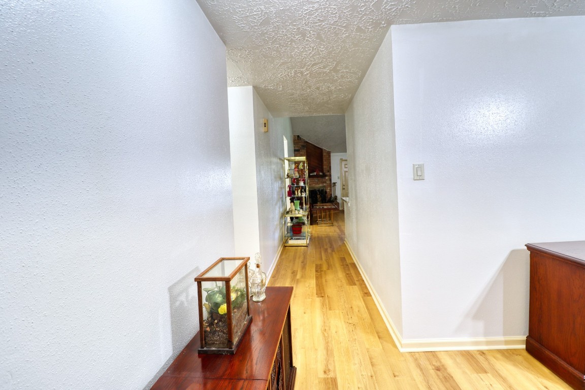 3446 Cheaney Drive Houston, TX 77066 - Photo 22 of 49 a view of a hallway with wooden floor and stairs