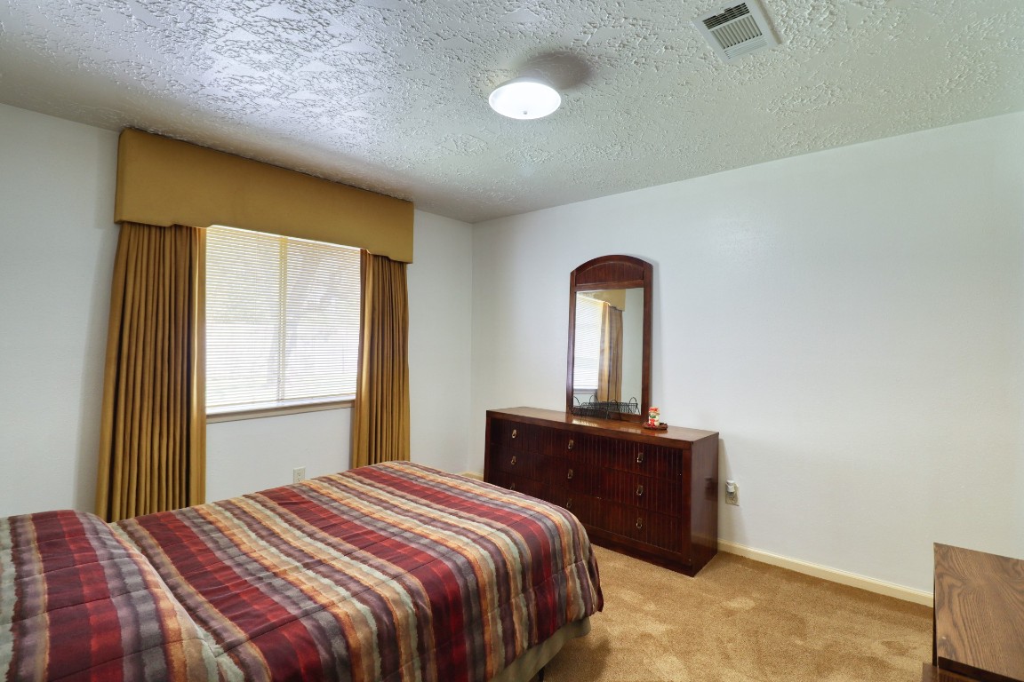 3446 Cheaney Drive Houston, TX 77066 - Photo 31 of 49 a bedroom with a bed and a dresser