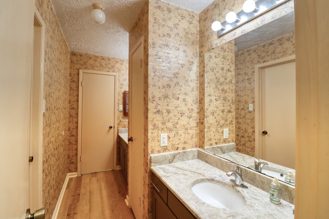 3446 Cheaney Drive Houston, TX 77066 - Photo 32 of 49 a bathroom with a granite countertop sink toilet and shower