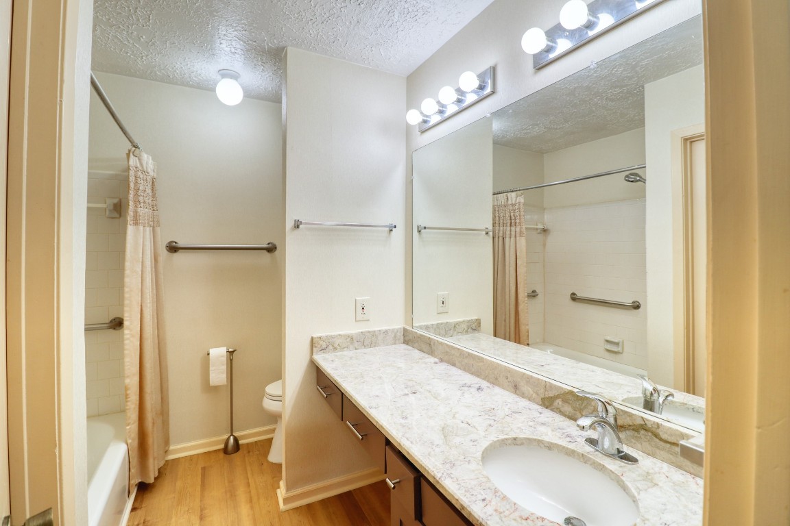 3446 Cheaney Drive Houston, TX 77066 - Photo 34 of 49 a bathroom with a granite countertop sink a mirror and a shower