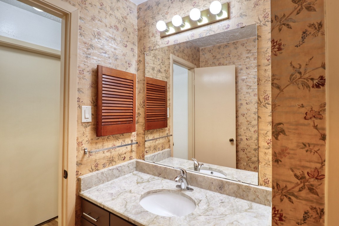3446 Cheaney Drive Houston, TX 77066 - Photo 37 of 49 a bathroom with a granite countertop sink and a mirror