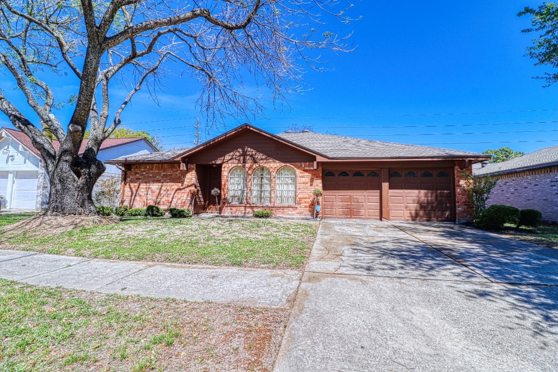 3446 Cheaney Drive Houston, TX 77066 - Photo 49 of 49 a front view of a house with a yard and garage