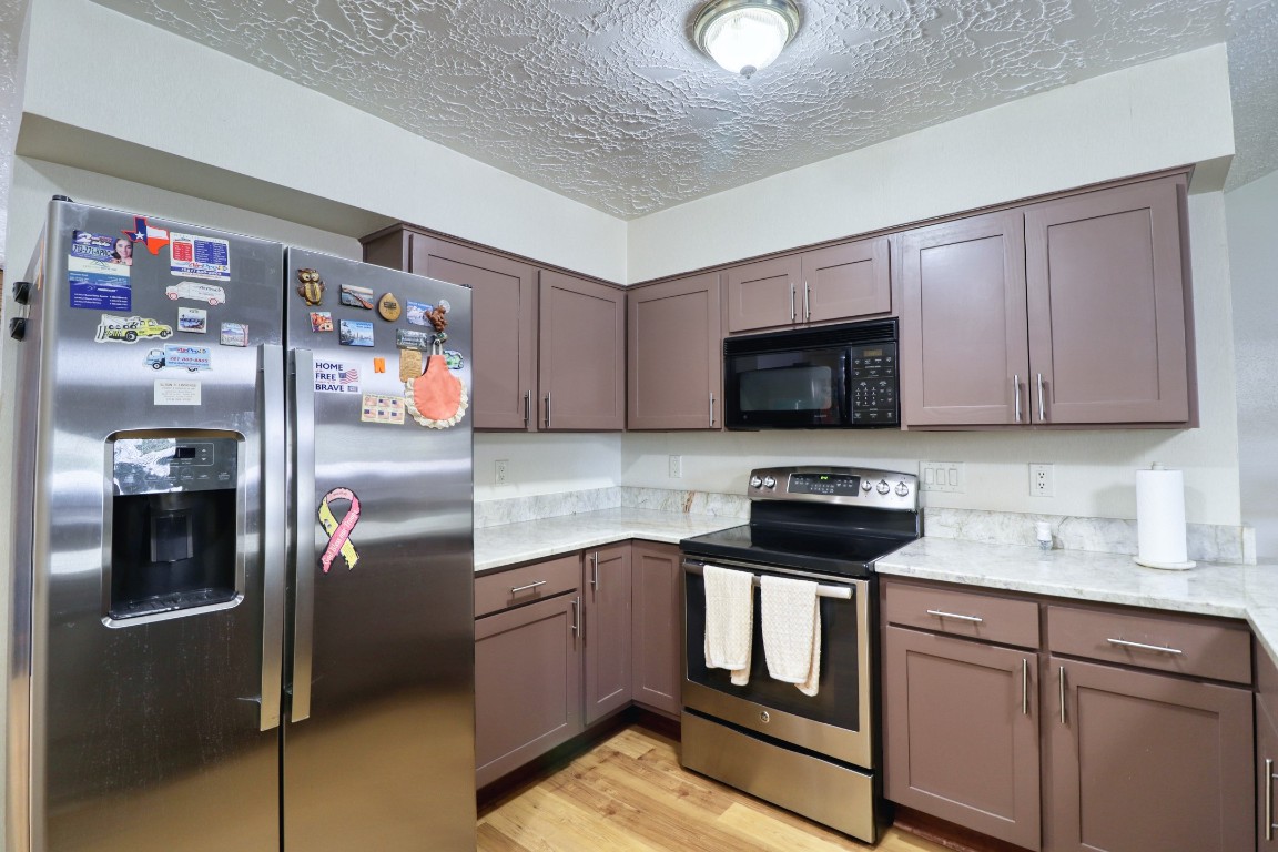 3446 Cheaney Drive Houston, TX 77066 - Photo 8 of 49 a kitchen with stainless steel appliances granite countertop a refrigerator stove and sink