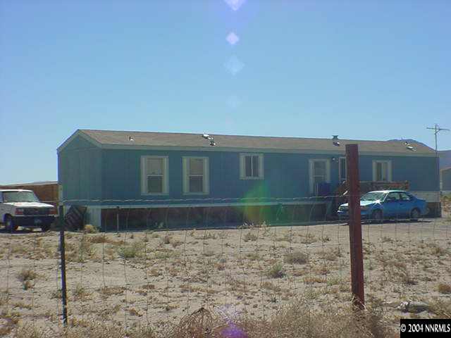 1445 Spruce Avenue Silver Springs, NV 89429 - Photo 1 of 1 a front view of a house with garden