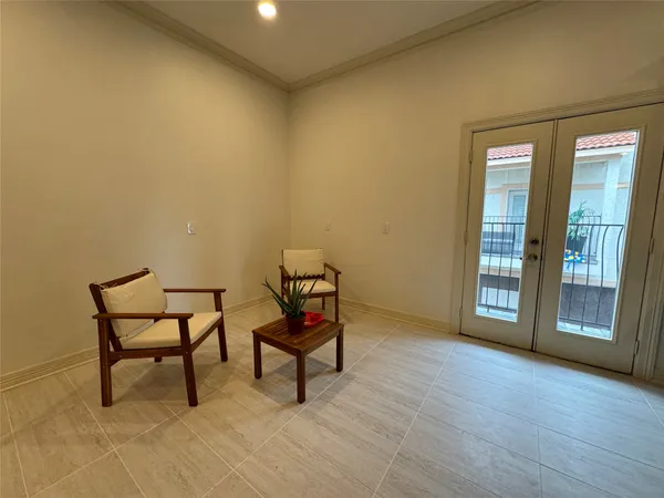 a kitchen with a refrigerator a stove and a dining table with wooden cabinet