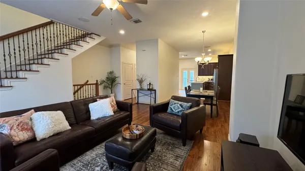 a living room with furniture and stairs