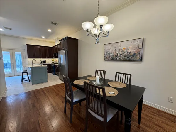 a kitchen with a refrigerator a microwave a sink and white cabinets