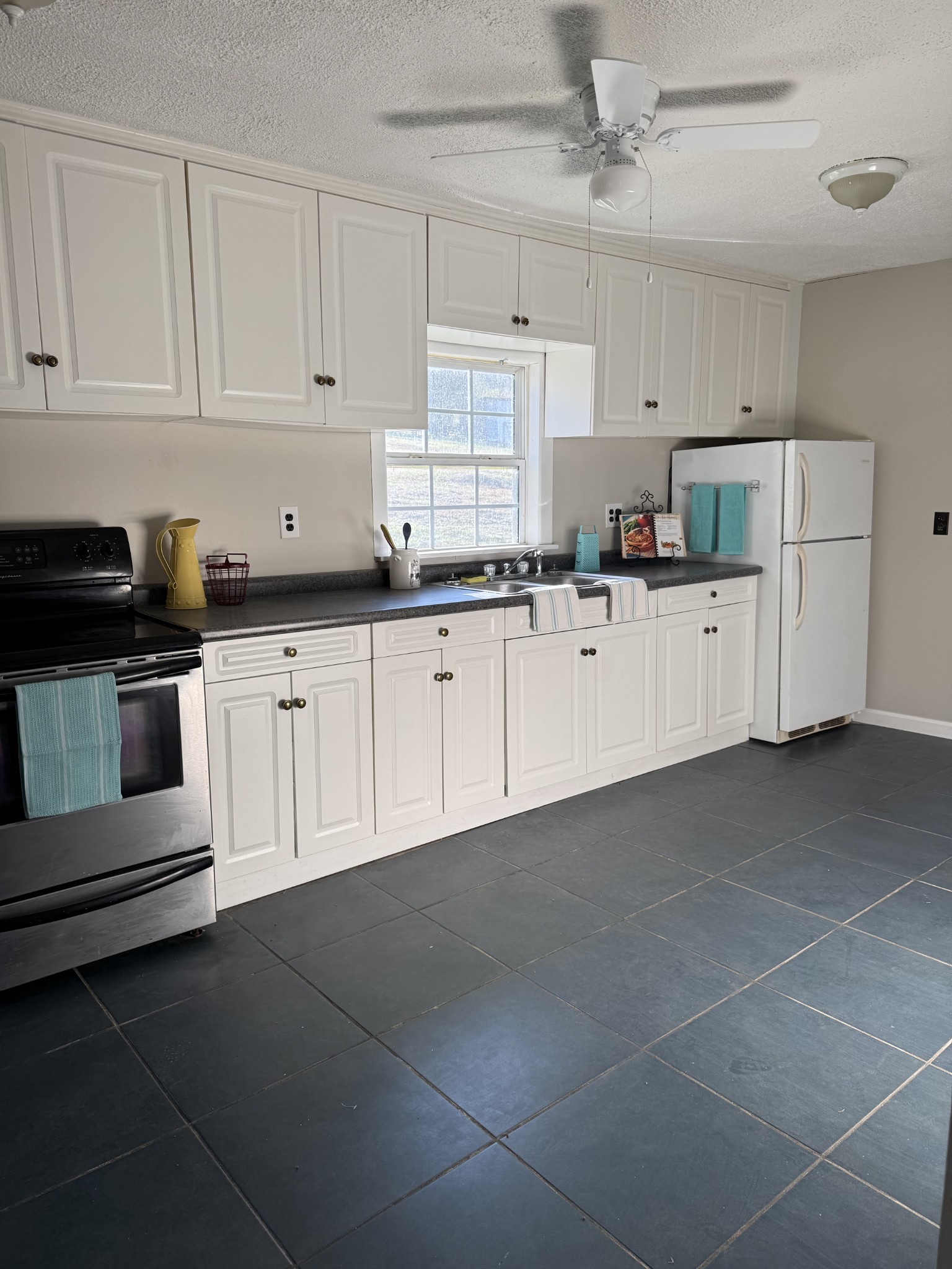 98 Ballenger Road Carthage, TN 37030 - Photo 12 of 23 a kitchen with cabinets and white appliances