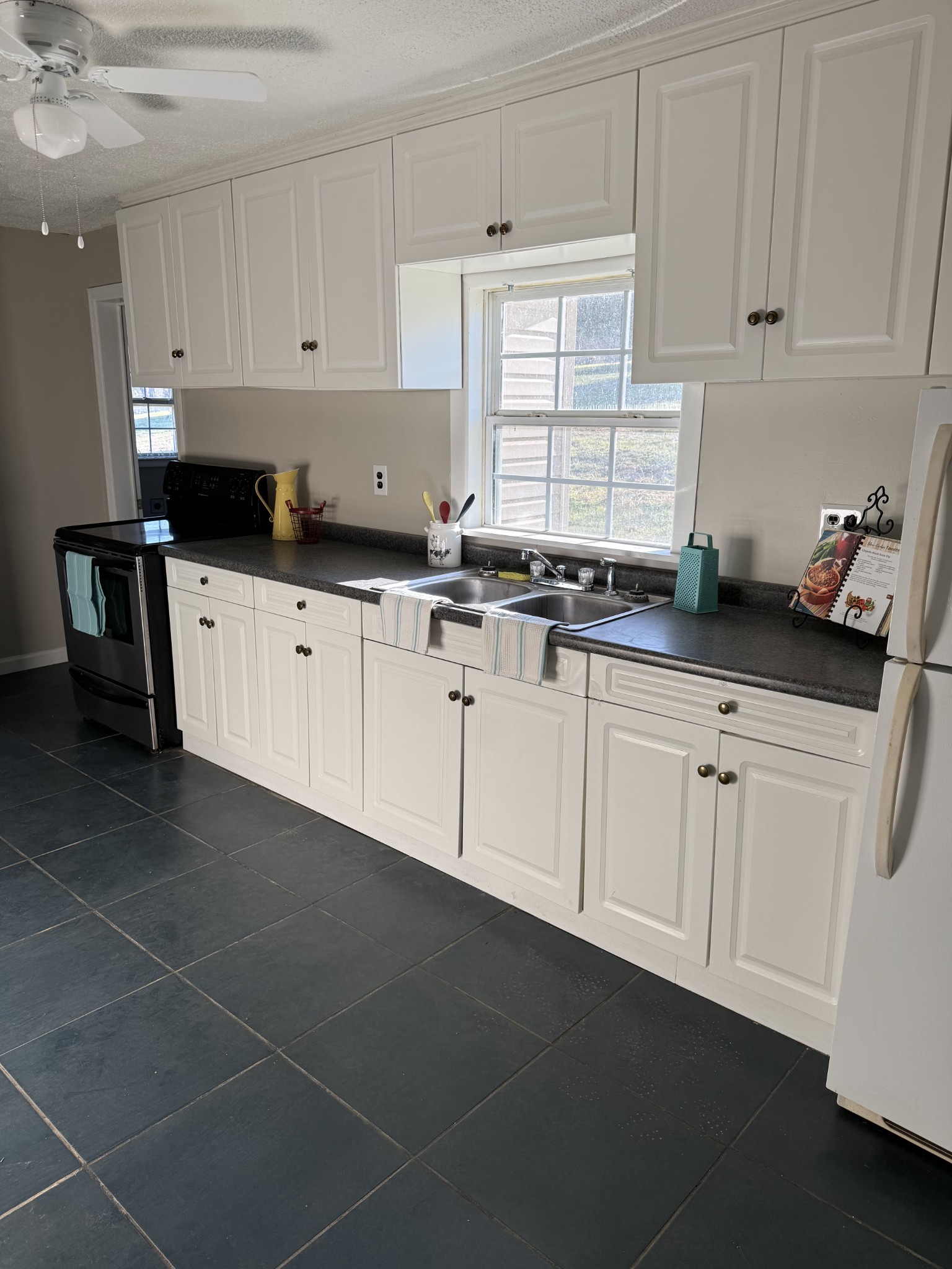 98 Ballenger Road Carthage, TN 37030 - Photo 13 of 23 a kitchen with granite countertop white cabinets and white appliances