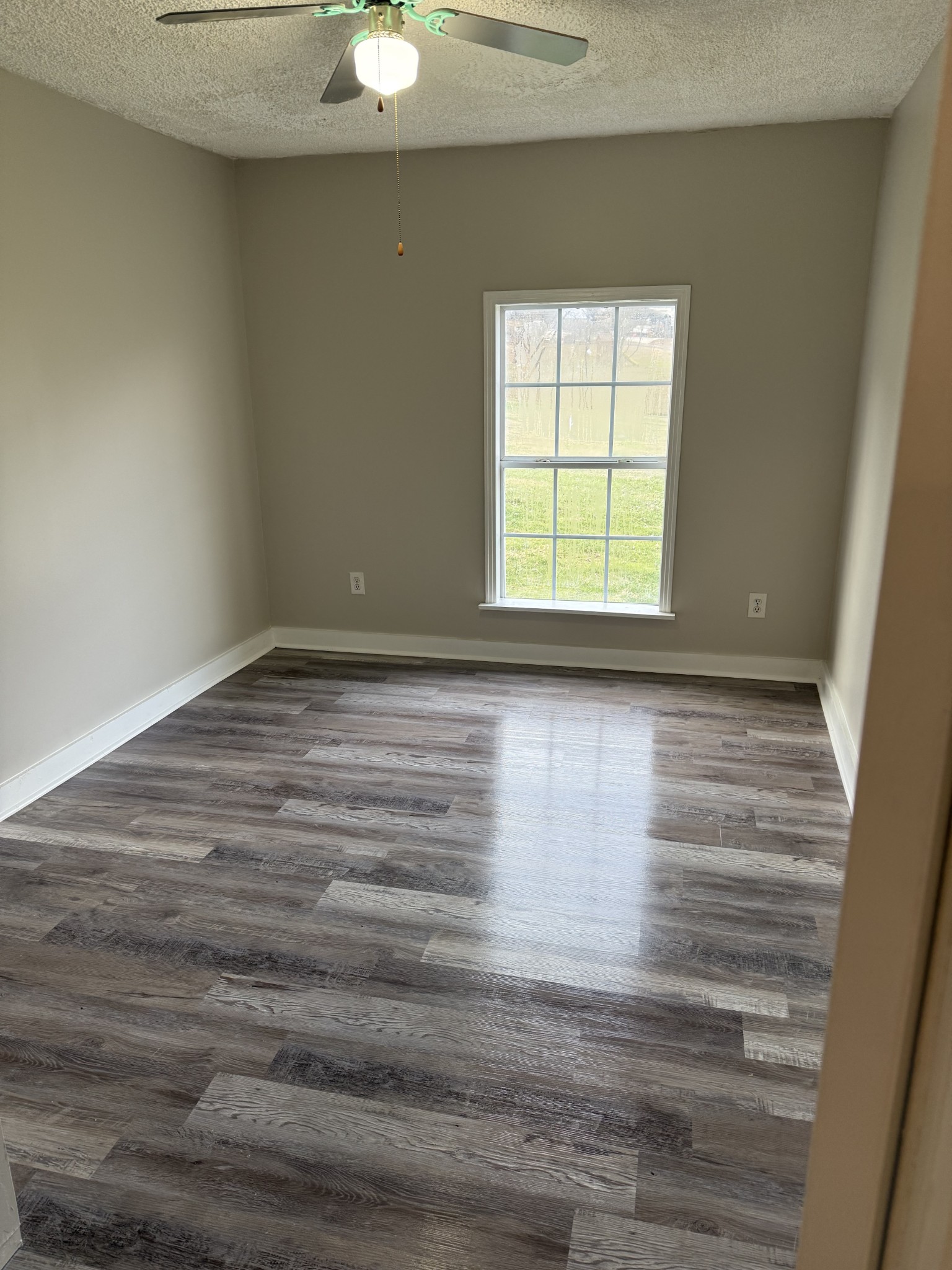 98 Ballenger Road Carthage, TN 37030 - Photo 19 of 23 a view of an empty room with wooden floor and a window