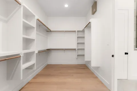 a view of walk in closet with empty racks