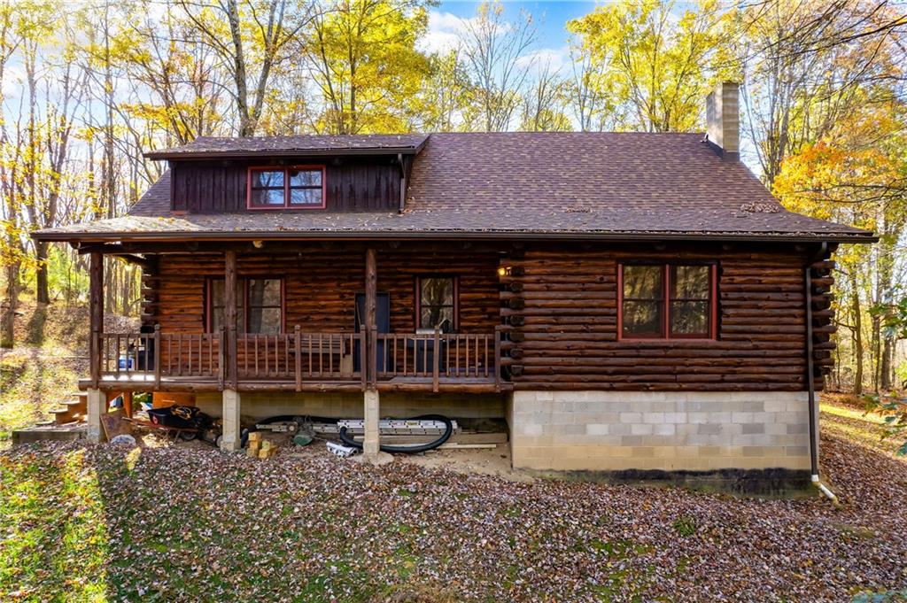 a view of a house with a yard and wooden fence