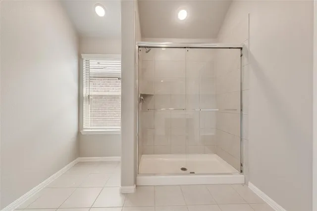 a spacious bathroom with a shower and a sink