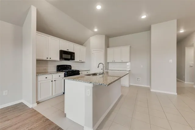 a kitchen with stainless steel appliances a sink stove and refrigerator