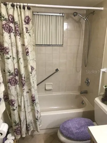 a bathroom with a shower and a bath tub