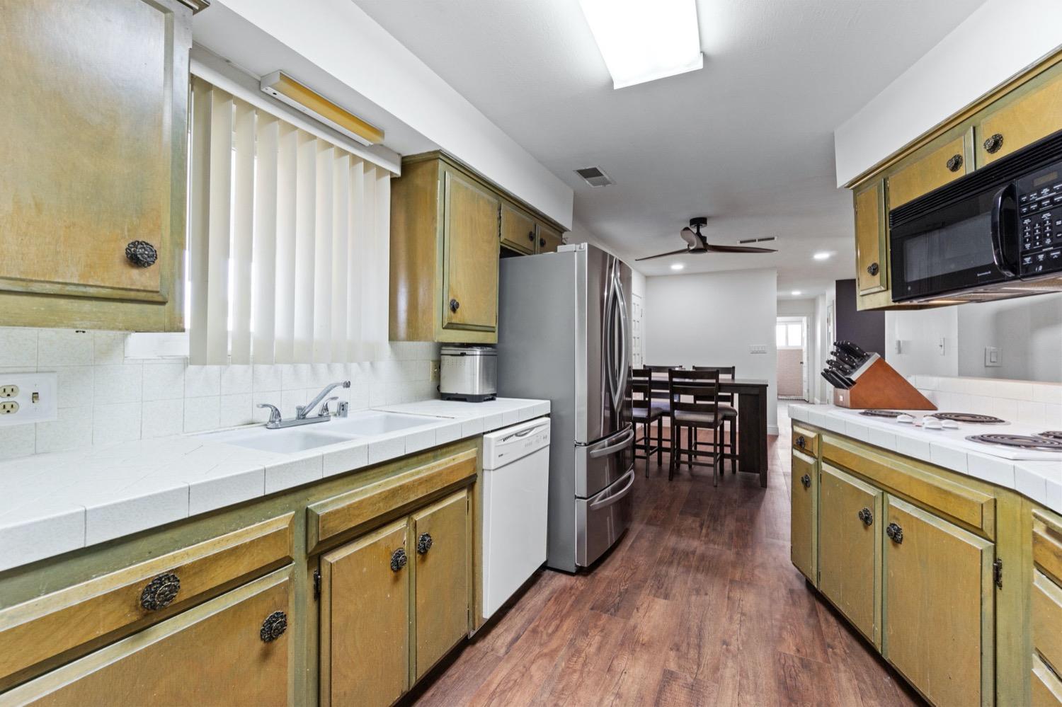 5654 North 7th Street Fresno, CA 93710 - Photo 12 of 38 a kitchen with a sink stove and cabinets