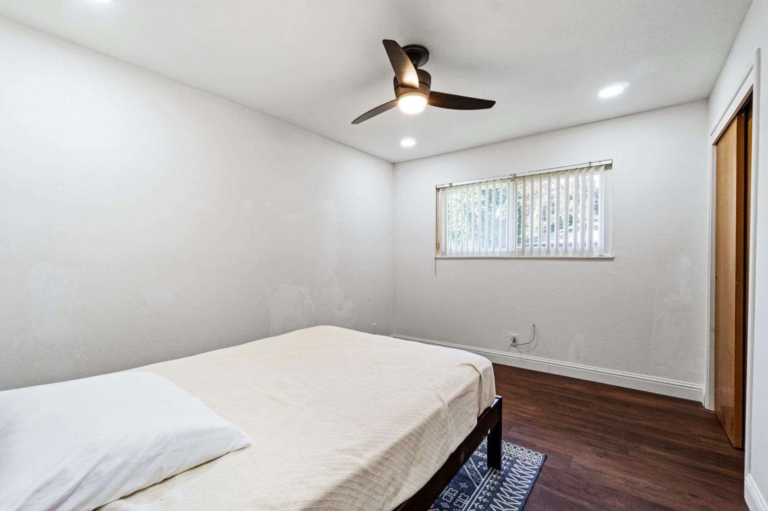 5654 North 7th Street Fresno, CA 93710 - Photo 22 of 38 a bedroom with a bed and a window