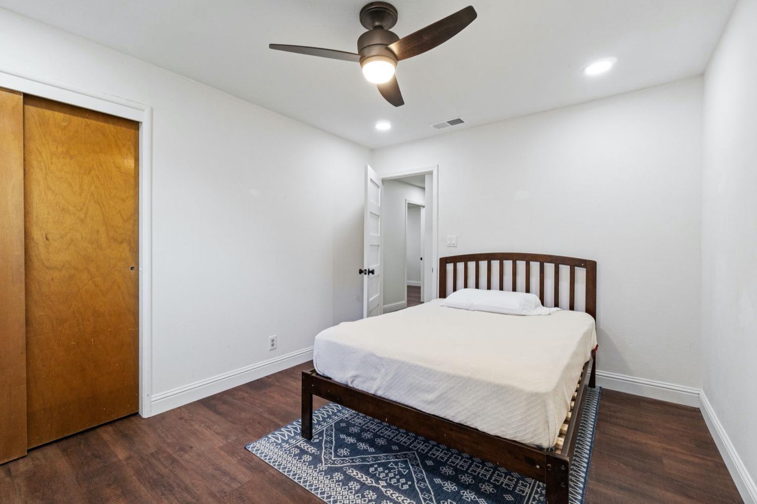 5654 North 7th Street Fresno, CA 93710 - Photo 23 of 38 a bedroom with a bed and wooden floor