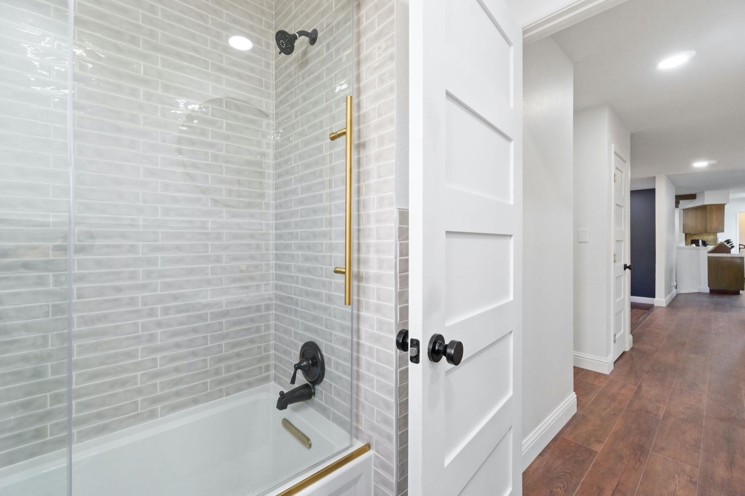5654 North 7th Street Fresno, CA 93710 - Photo 26 of 38 a bathroom with a bathtub and a shower