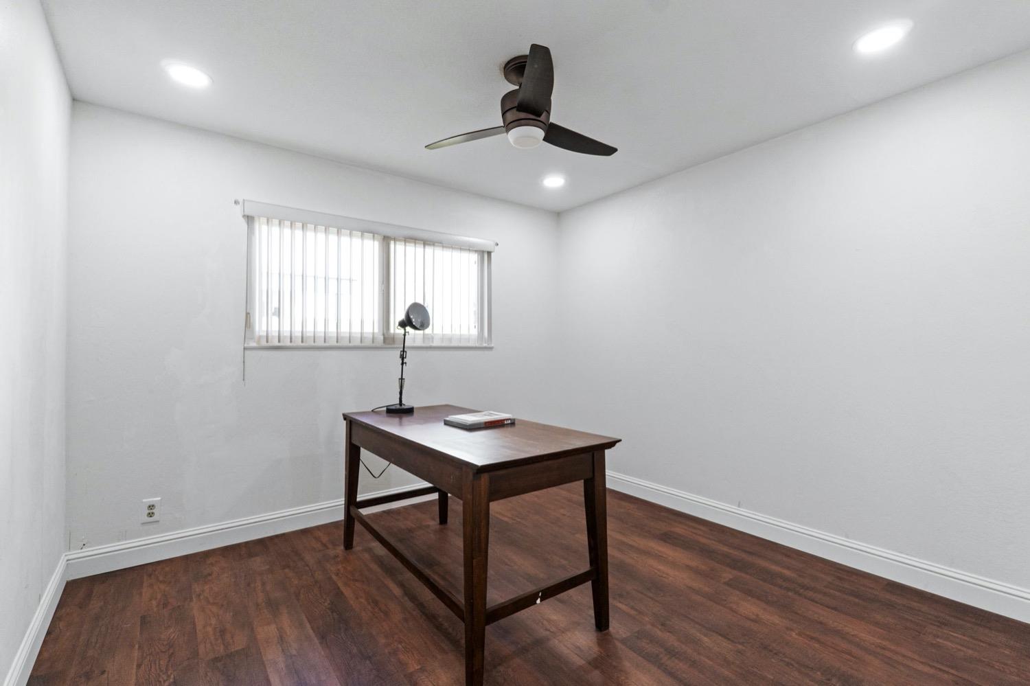 5654 North 7th Street Fresno, CA 93710 - Photo 27 of 38 a view of a workspace with furniture and wooden floor