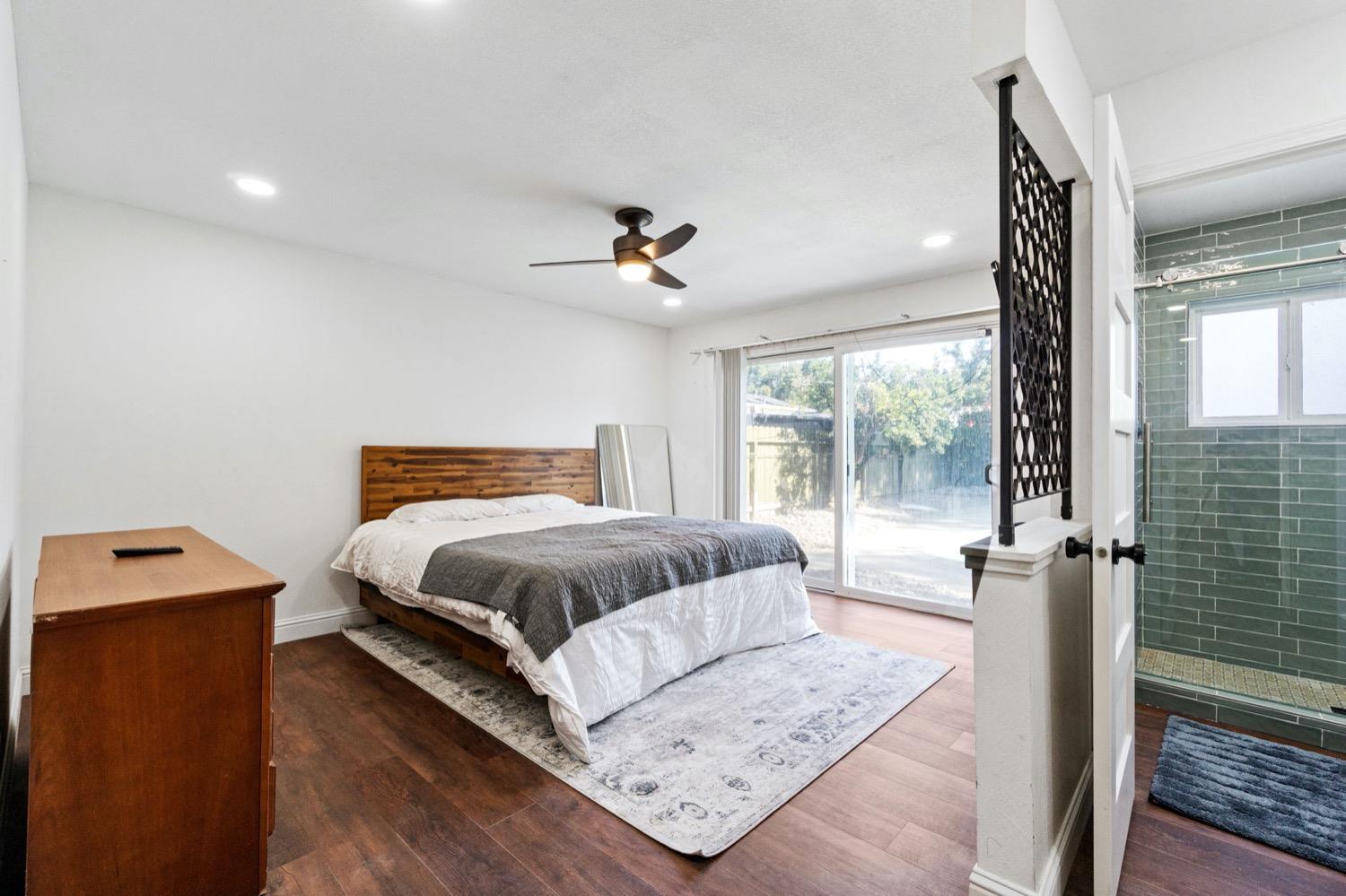 5654 North 7th Street Fresno, CA 93710 - Photo 29 of 38 a bedroom with a bed and wooden floor