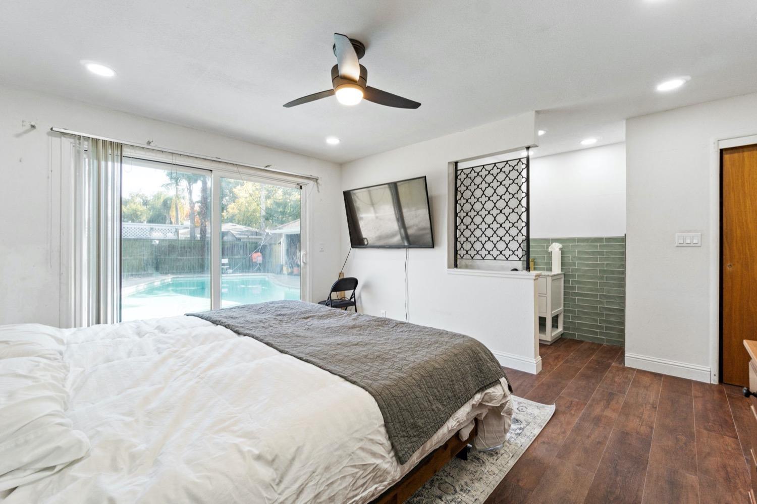 5654 North 7th Street Fresno, CA 93710 - Photo 30 of 38 a spacious bedroom with a large bed and a dresser