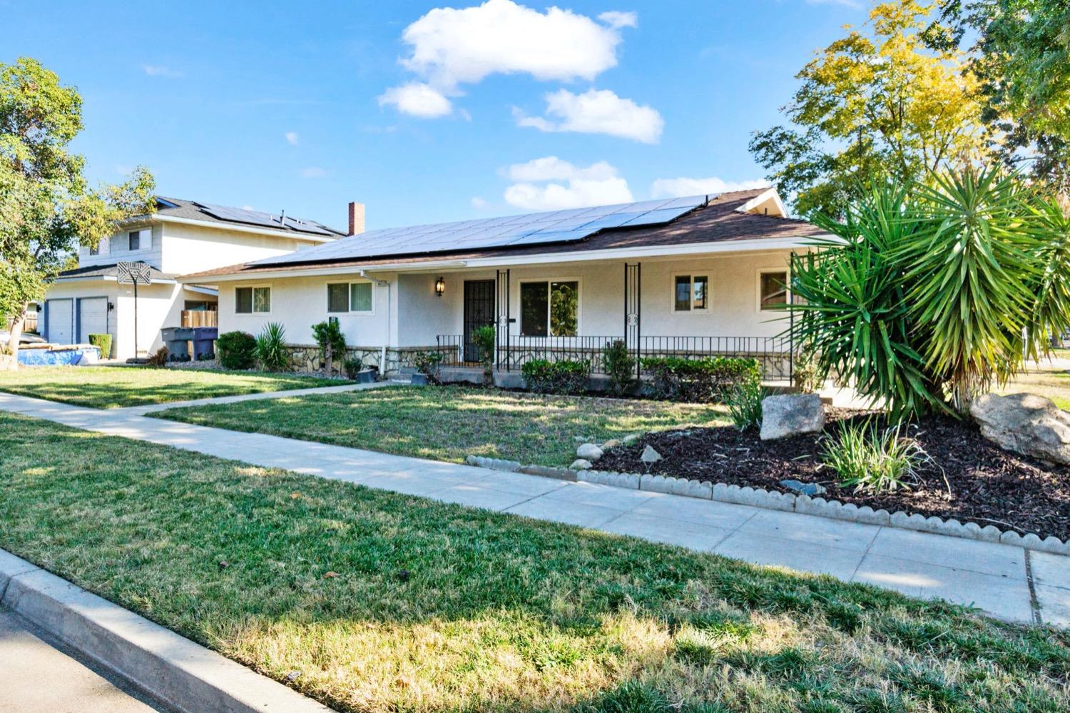 5654 North 7th Street Fresno, CA 93710 - Photo 3 of 38 a front view of a house with a garden