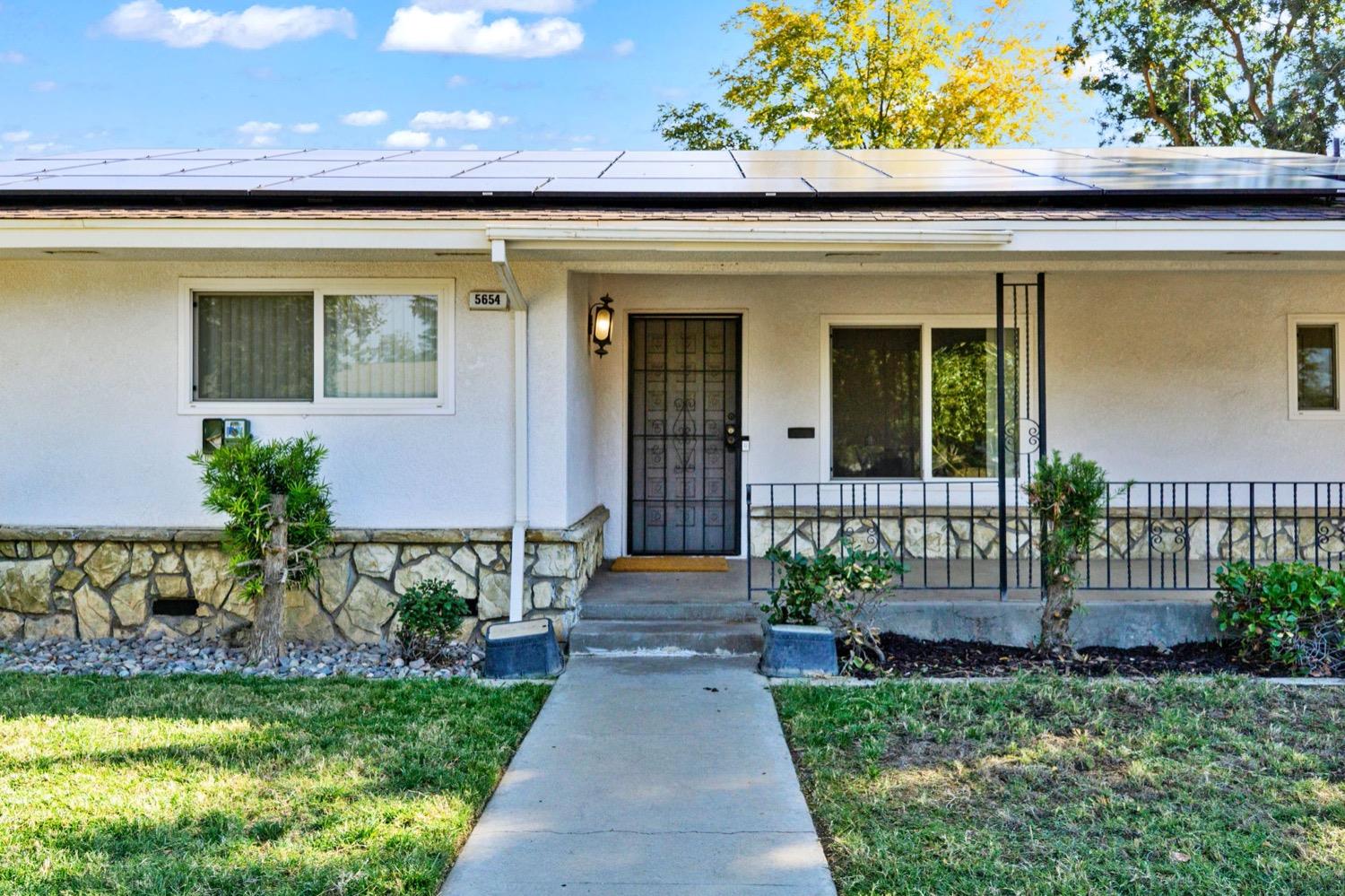 5654 North 7th Street Fresno, CA 93710 - Photo 5 of 38 a front view of a house with garden