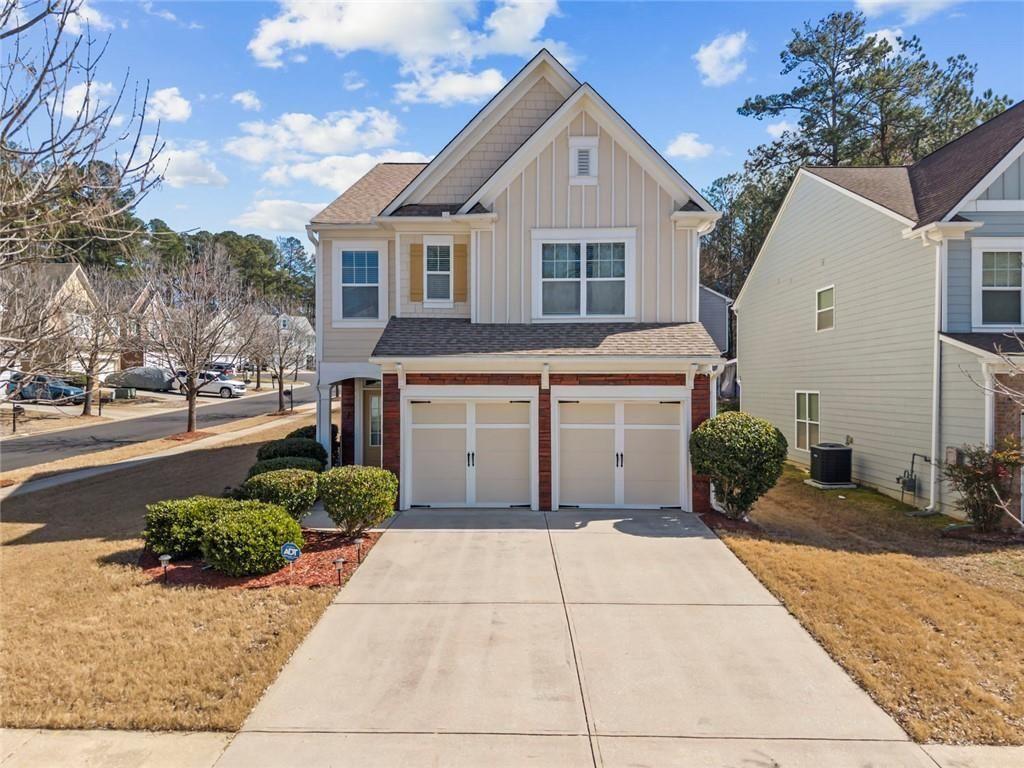 6066 Allpoint Way Fairburn, GA 30213 - Photo 1 of 43 a front view of a house with a yard and potted plants