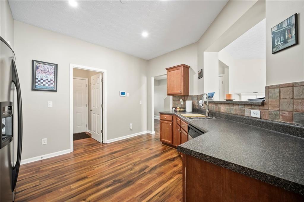 6066 Allpoint Way Fairburn, GA 30213 - Photo 17 of 43 a kitchen with stainless steel appliances granite countertop a refrigerator and a stove top oven