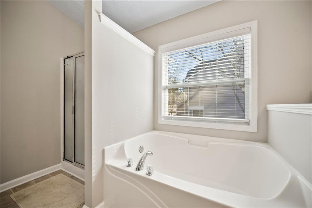 6066 Allpoint Way Fairburn, GA 30213 - Photo 23 of 43 a white bath tub sitting next to a window