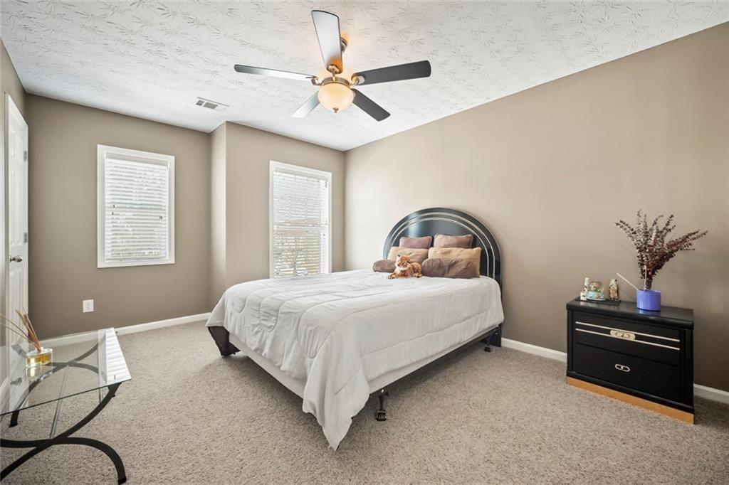 6066 Allpoint Way Fairburn, GA 30213 - Photo 25 of 43 a bedroom with a bed dresser and a window