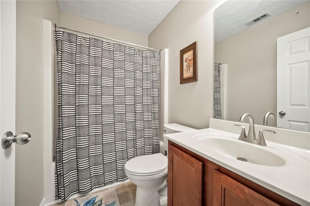 6066 Allpoint Way Fairburn, GA 30213 - Photo 30 of 43 a bathroom with a sink toilet and shower