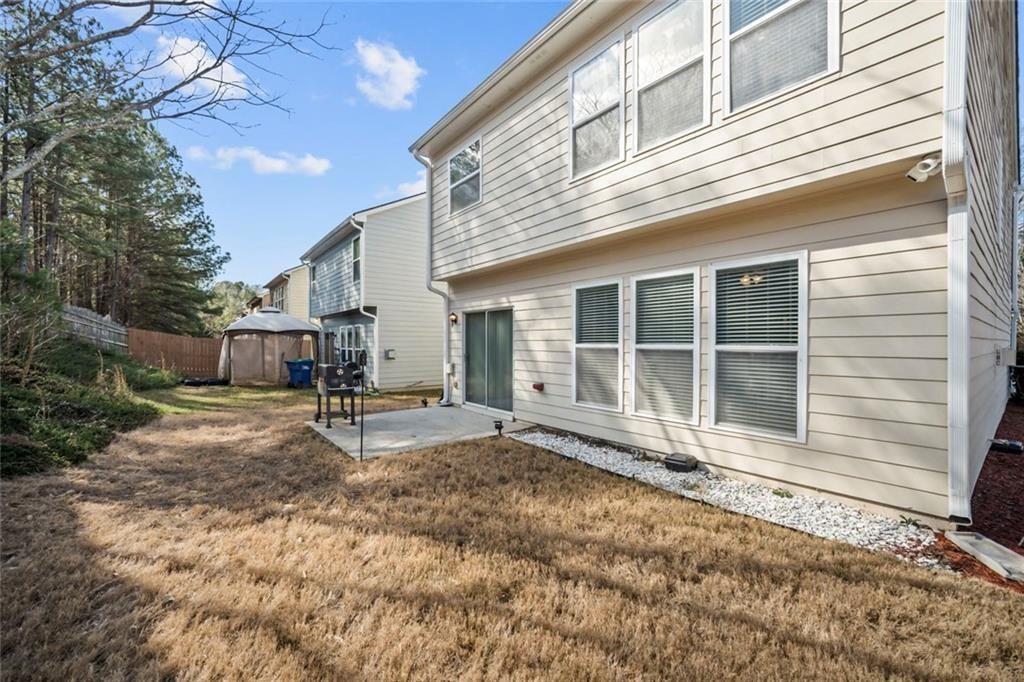 6066 Allpoint Way Fairburn, GA 30213 - Photo 34 of 43 a house with trees in the background