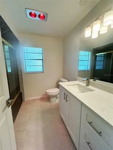 a bathroom with a sink a toilet and a mirror