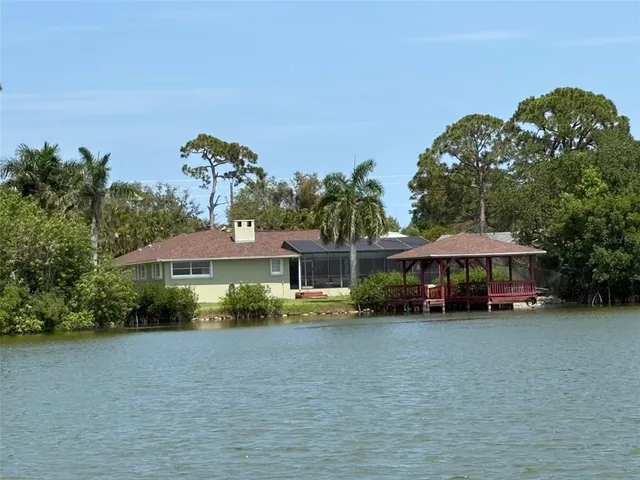 a view of a house with a yard and sitting area