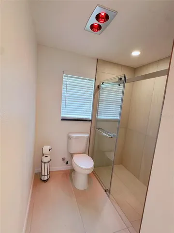a bathroom with a toilet and a shower