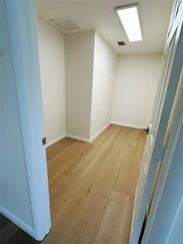 an empty room with wooden floor