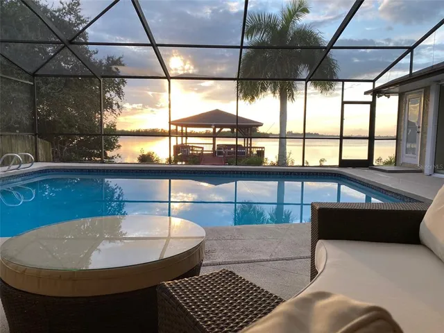 a dining room with furniture and a table and potted plants
