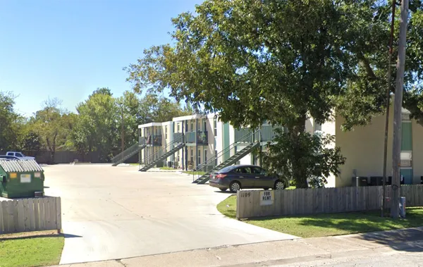 a view of a building with a yard