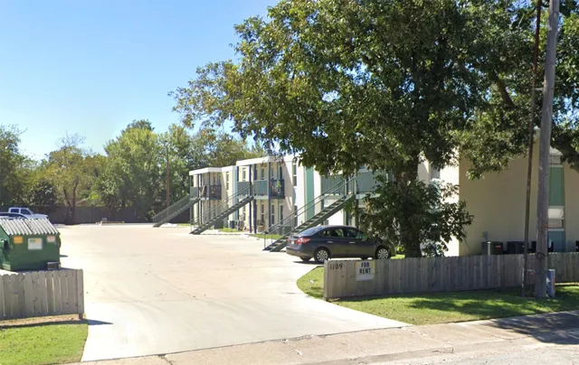 a view of a building with a yard