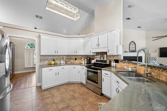 a view of a patio with a table chairs and a floor to ceiling window
