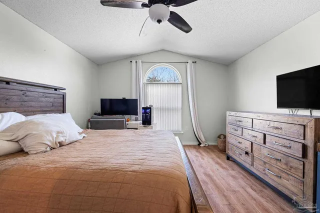 a view of a backyard with a patio and swimming pool