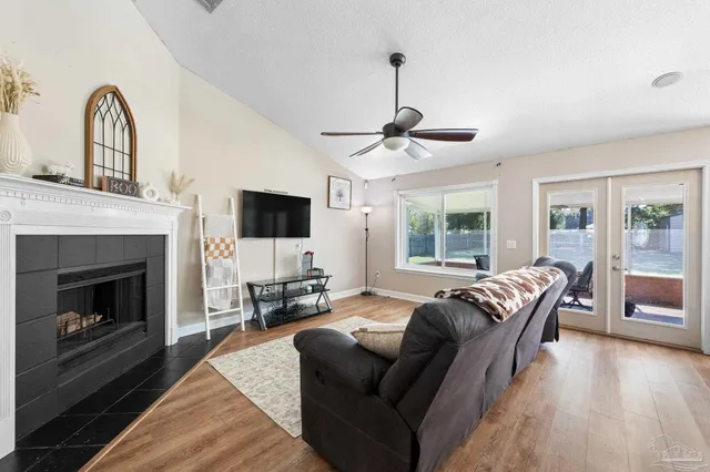 a dining room with furniture a chandelier and wooden floor