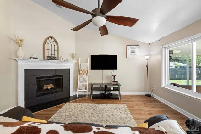a kitchen with stainless steel appliances granite countertop a dining table chairs and a refrigerator