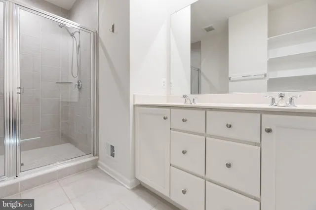 a bathroom with a shower sink and mirror