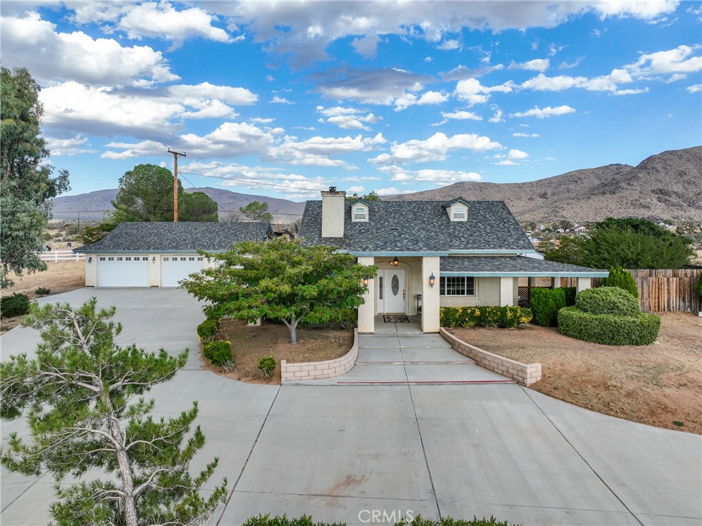 25375 Cahuilla Road Apple Valley, CA 92307 - Photo 1 of 1 a front view of a house with a garden