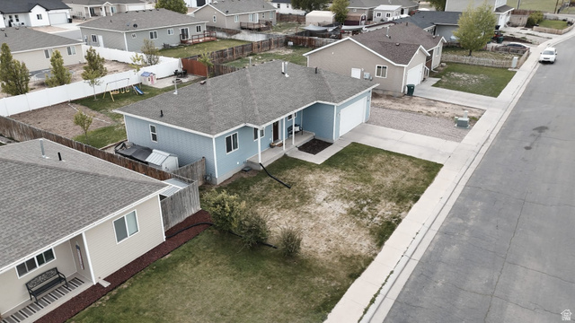 1437 925 South Vernal, UT 84078 - Photo 37 of 47 Light blue exterior with white trim, featuring a concrete driveway and an attached two-car garage